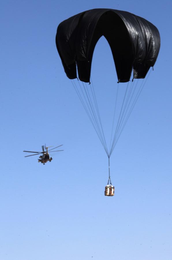 Cargo bundle descending under a parachute